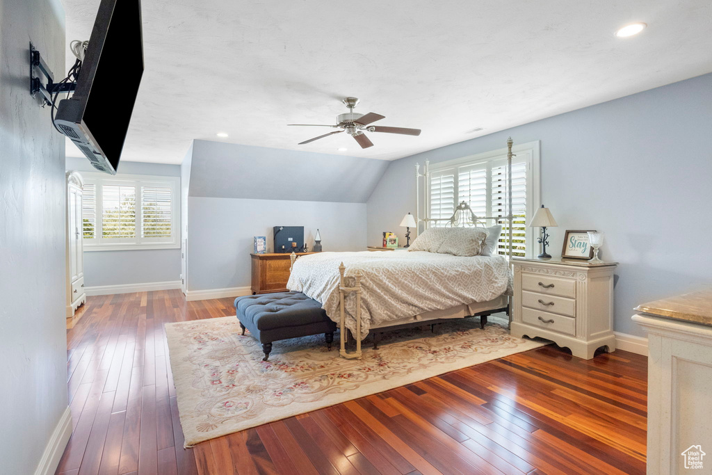 Bedroom featuring multiple windows, light hardwood / wood-style floors, ceiling fan, and vaulted ceiling