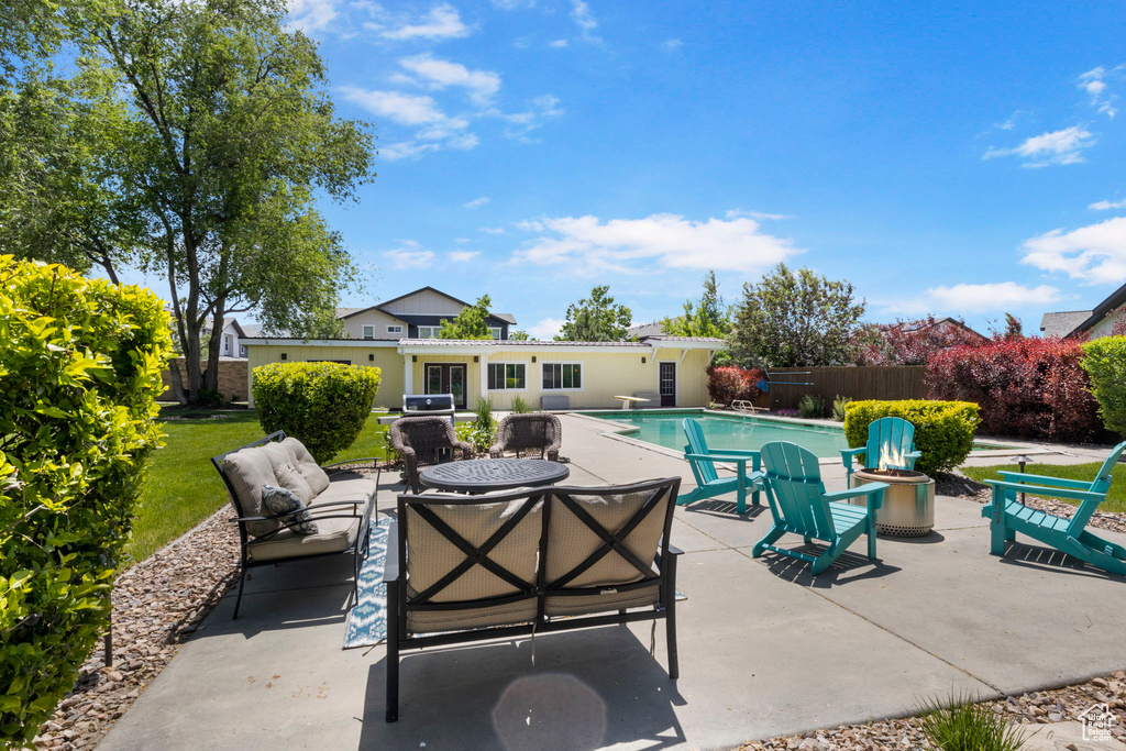 View of patio with a fenced in pool