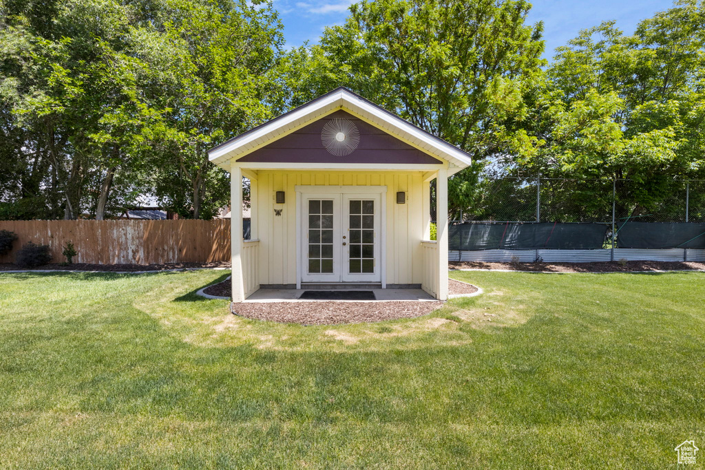 View of outdoor structure featuring a yard