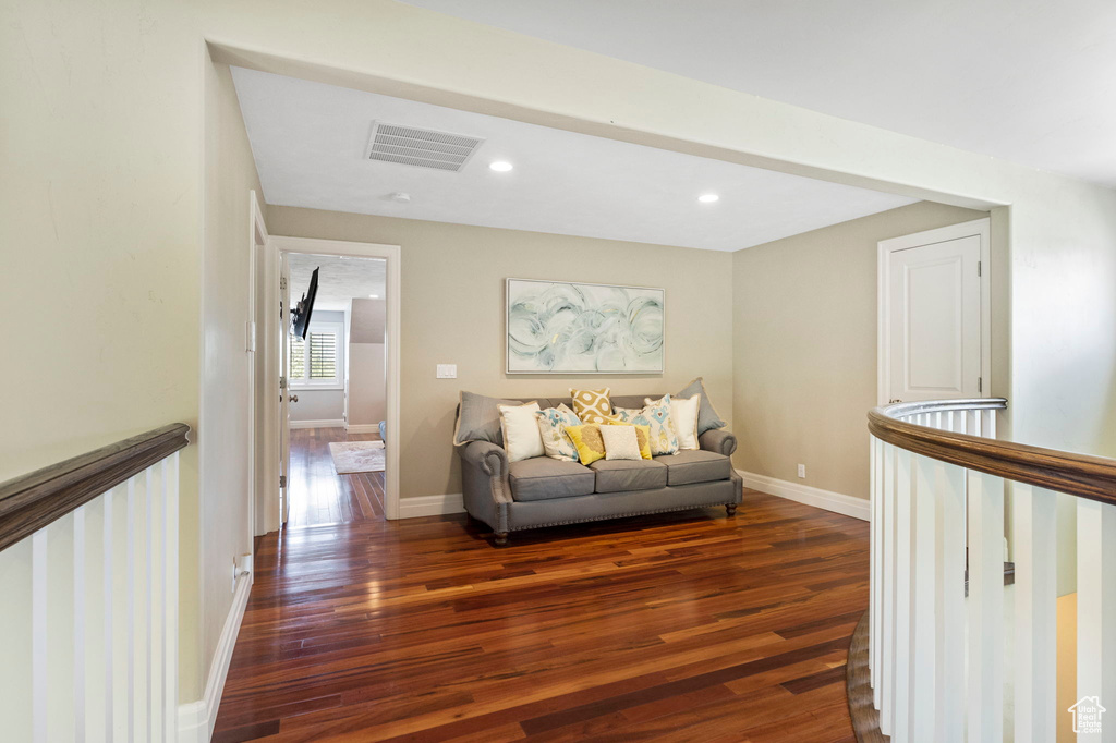 Living room with dark hardwood / wood-style flooring