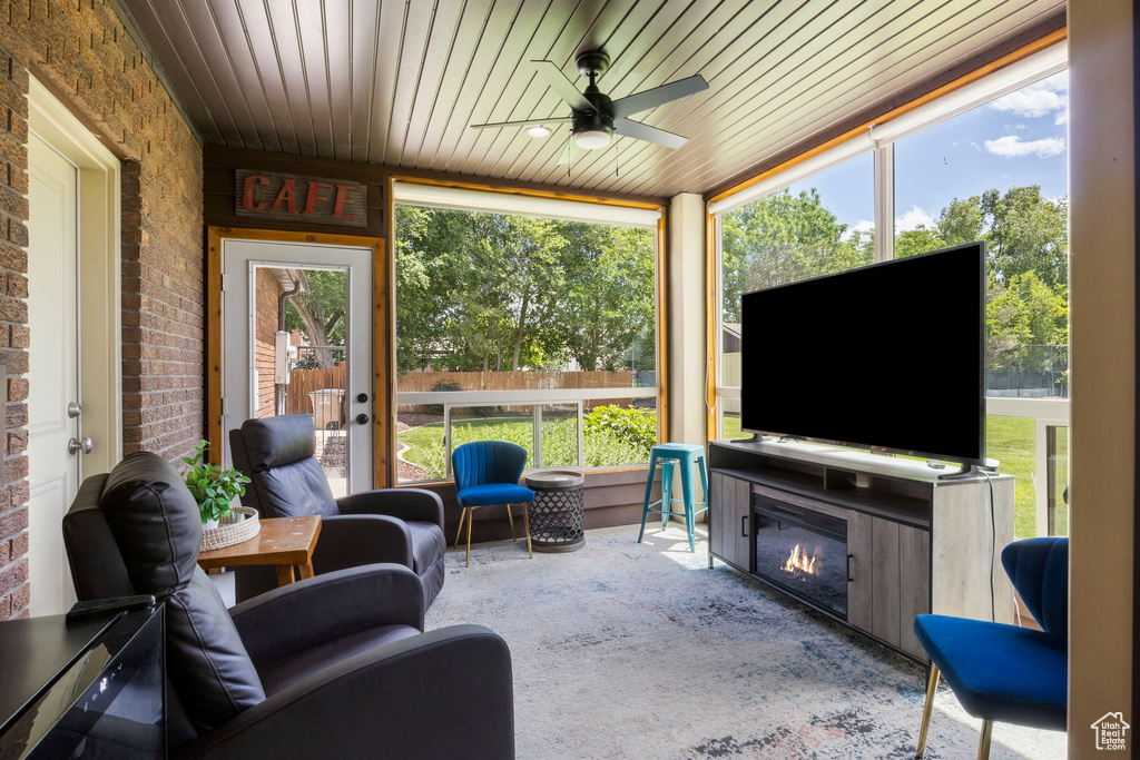 Sunroom featuring ceiling fan and wood ceiling