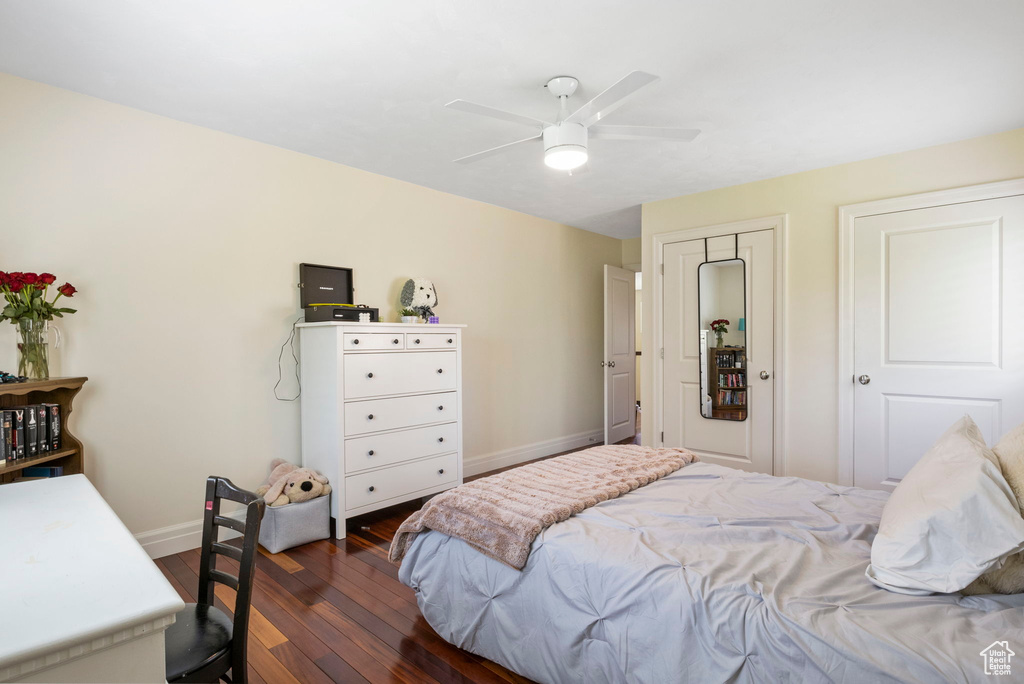 Bedroom with ceiling fan and dark hardwood / wood-style flooring