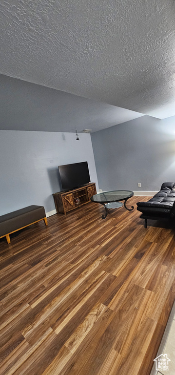 Interior space with a textured ceiling and hardwood / wood-style floors