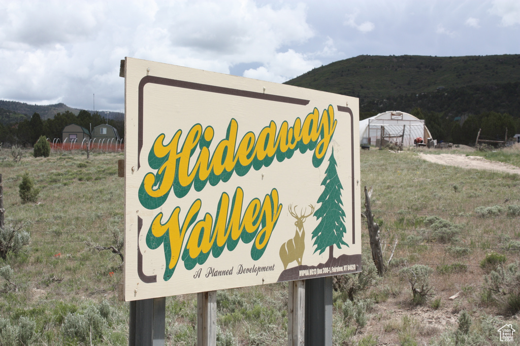 Community sign with a mountain view