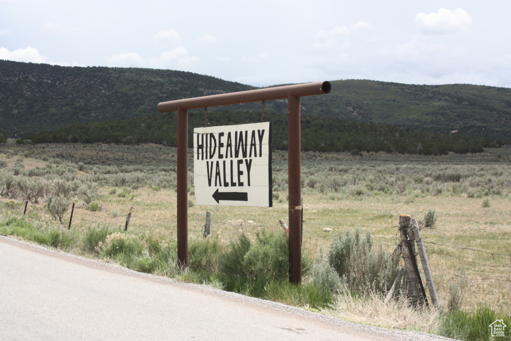 Community sign featuring a mountain view