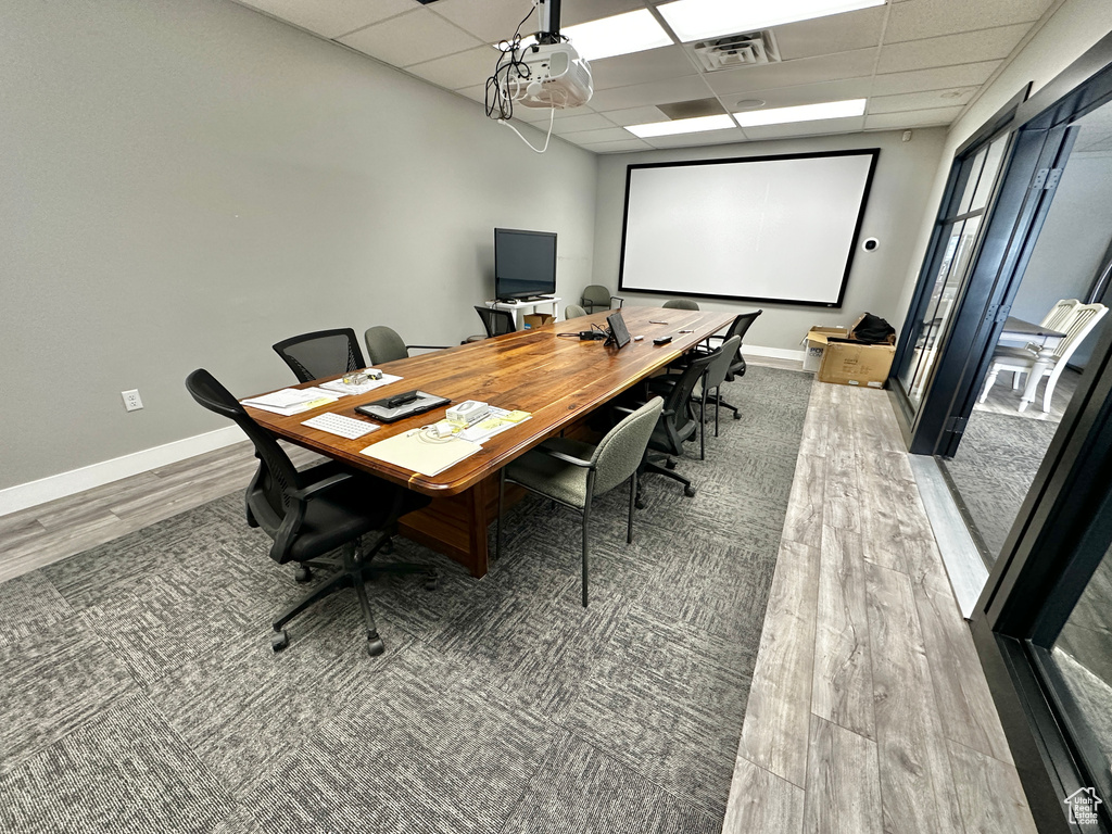 Office space with carpet flooring and a drop ceiling