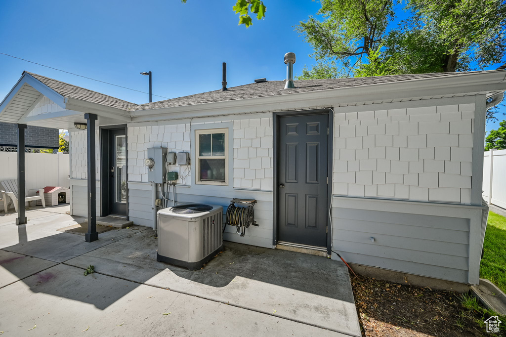 View of front of house featuring central AC unit and a patio