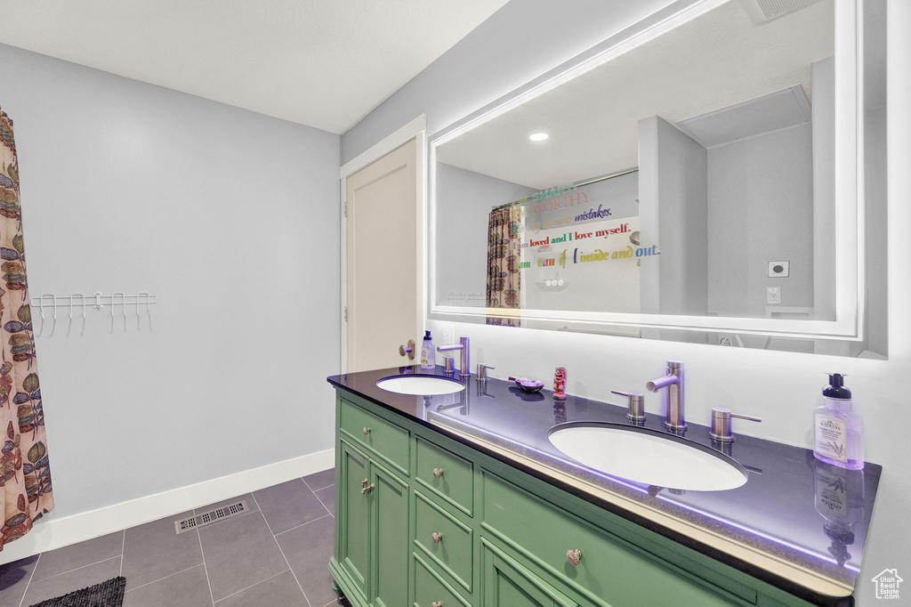 Bathroom with double vanity and tile floors