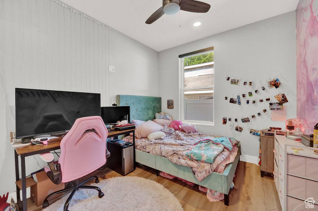 Bedroom with ceiling fan and light hardwood / wood-style flooring