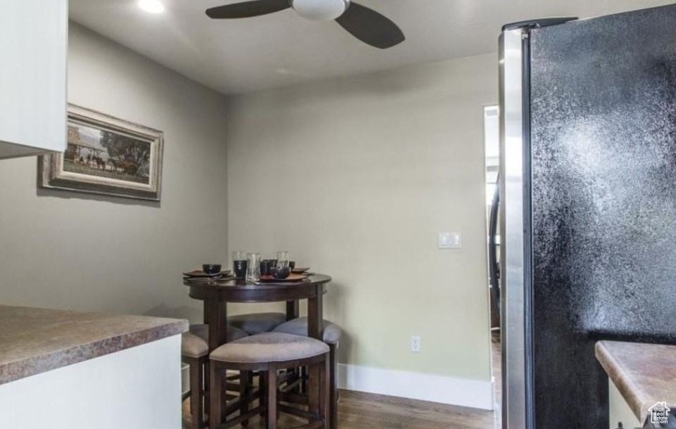 Dining room with ceiling fan and hardwood / wood-style floors