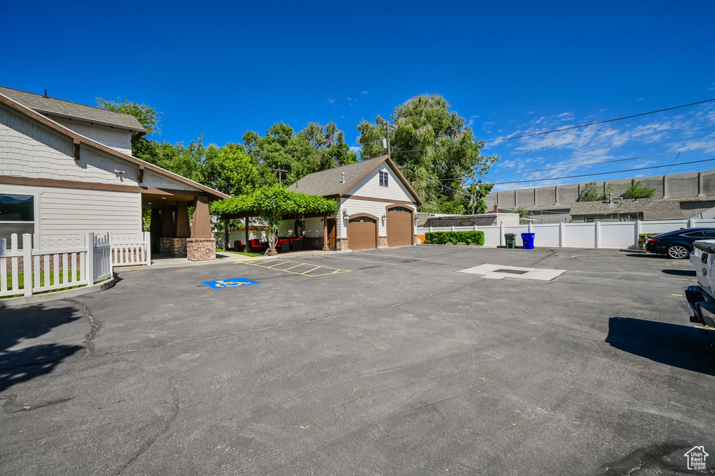 View of vehicle parking featuring a garage