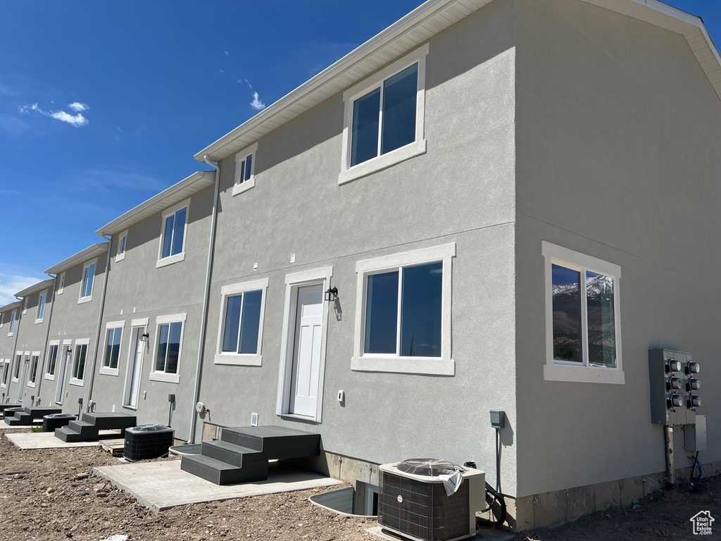 Back of house featuring central AC