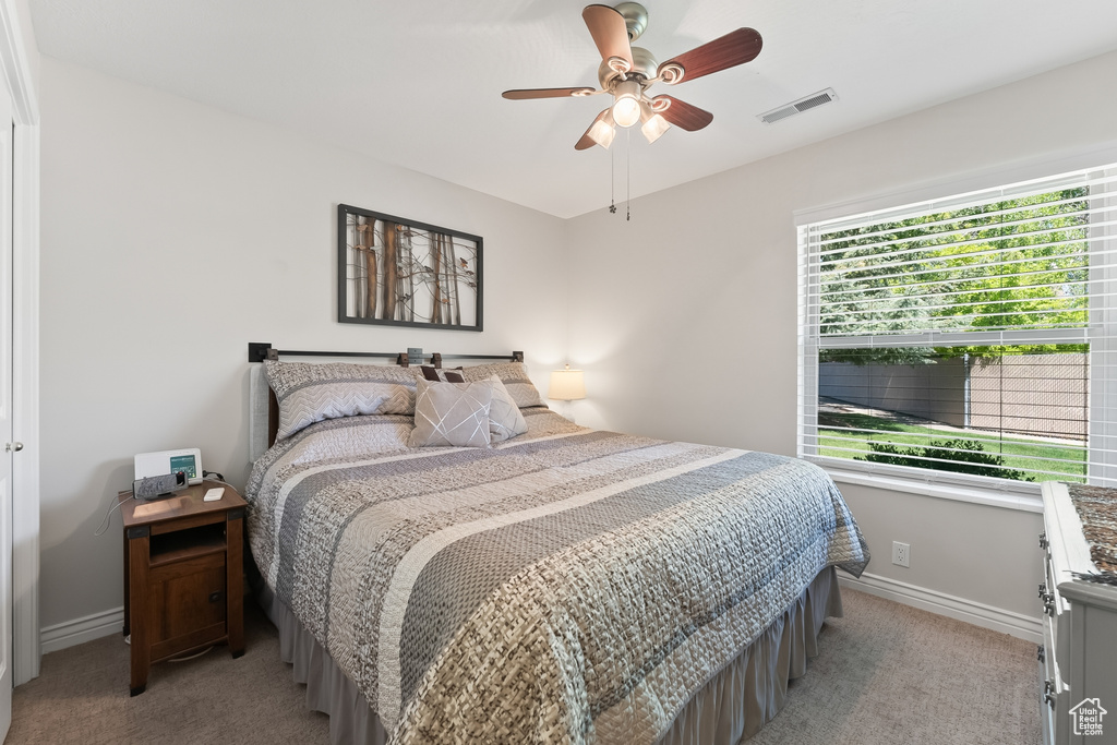 Bedroom featuring ceiling fan and light colored carpet