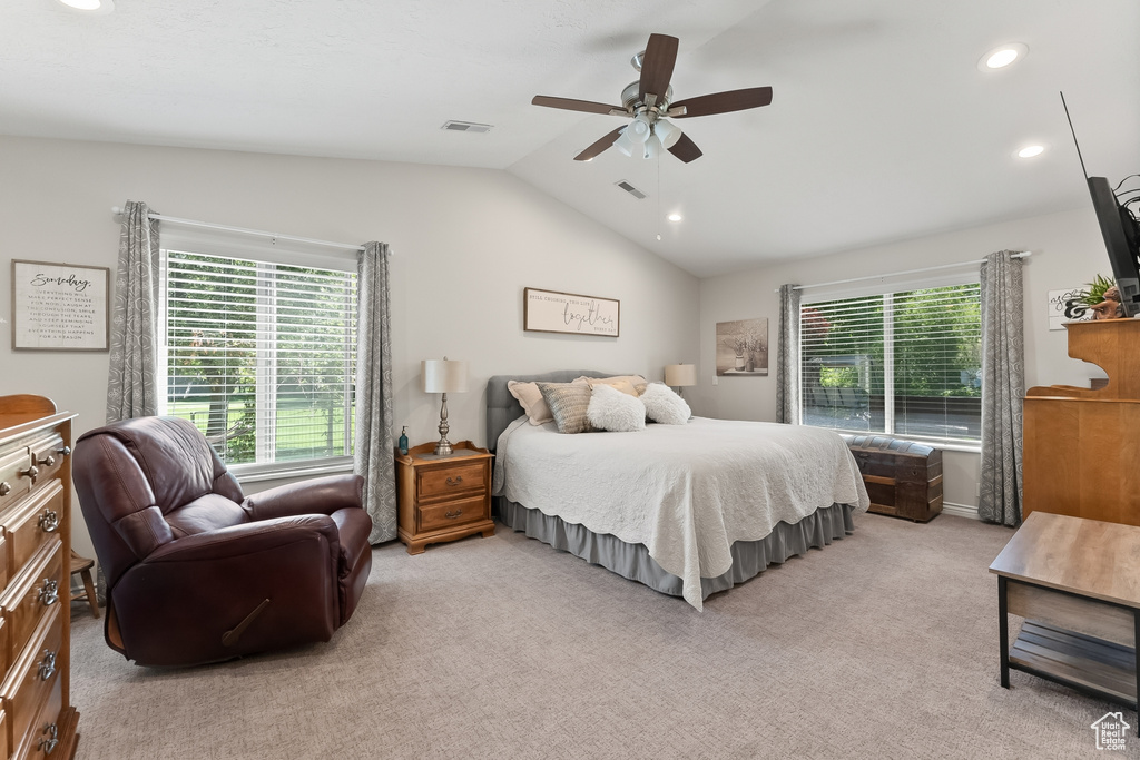 Bedroom featuring ceiling fan, lofted ceiling, and light colored carpet