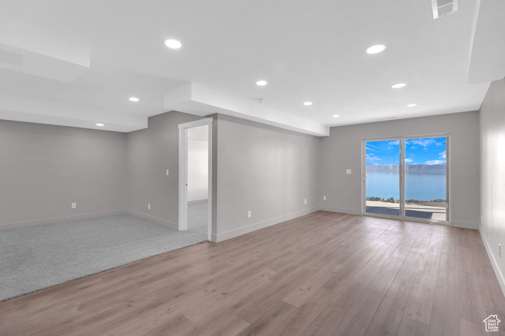 Unfurnished room featuring light wood-type flooring and a water view