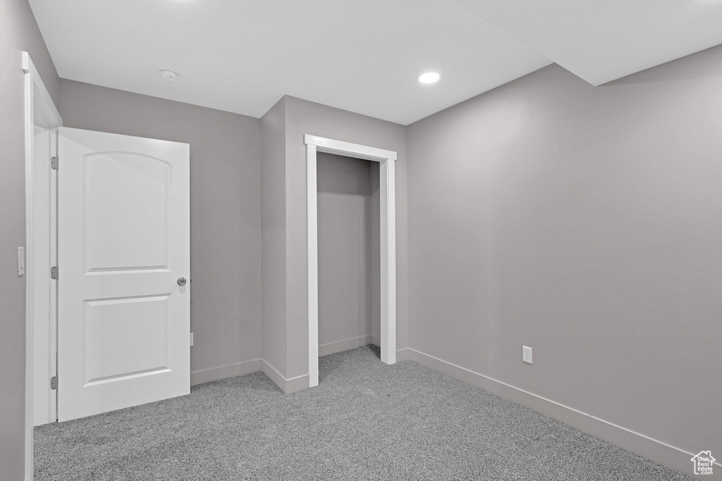 Unfurnished bedroom featuring light colored carpet and a closet