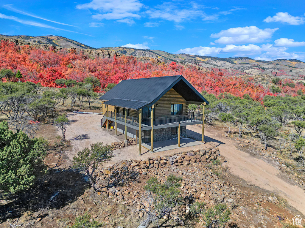 Back of house with a deck with mountain view