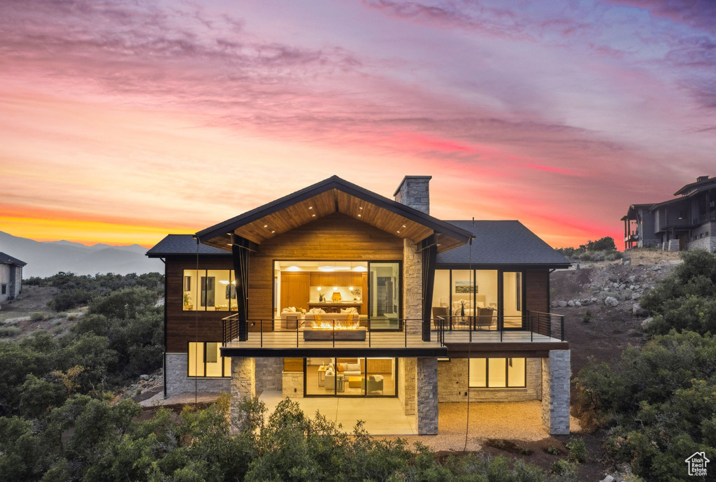 Back house at dusk with a balcony