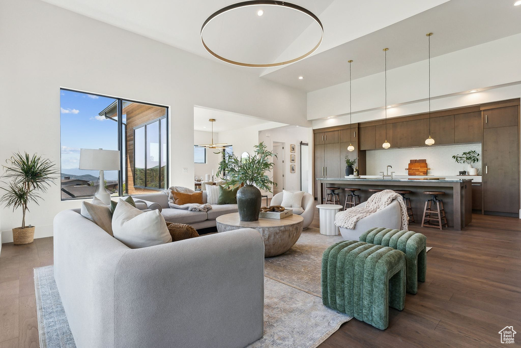 Living room with hardwood / wood-style flooring and sink