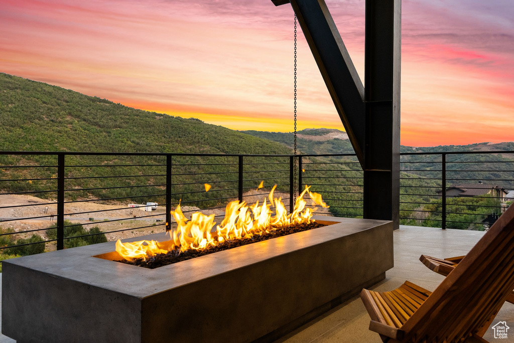 Patio terrace at dusk with a mountain view and an outdoor fire pit