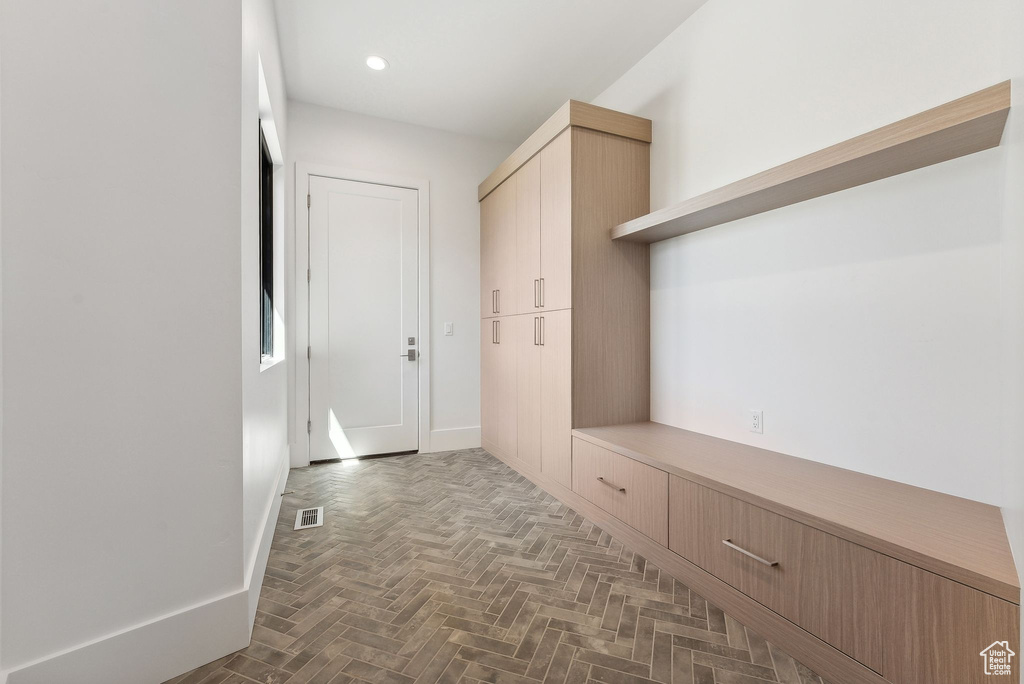 Mudroom featuring parquet flooring