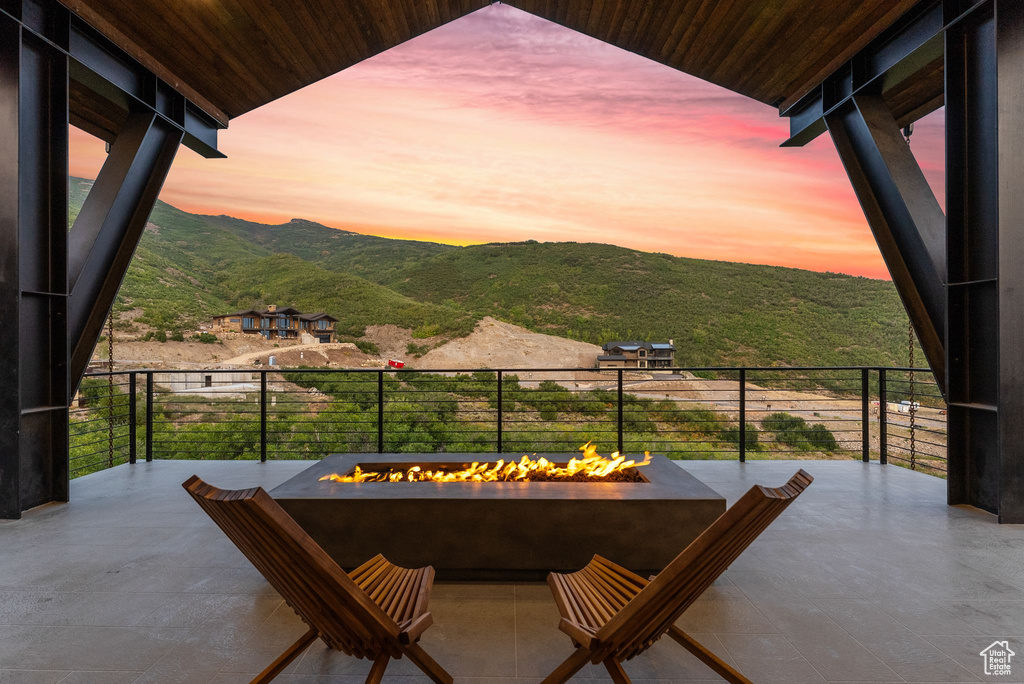 Balcony at dusk with a mountain view and a fire pit