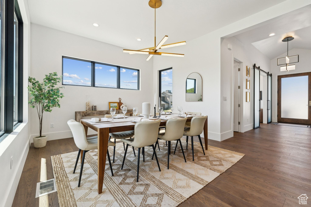 Dining room featuring lofted ceiling and dark hardwood / wood-style floors