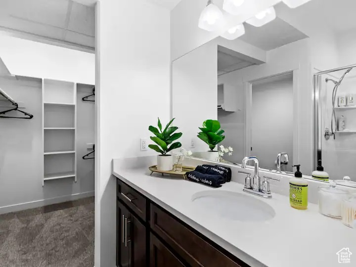 Bathroom with vanity with extensive cabinet space