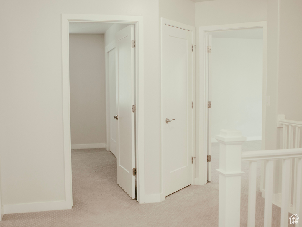 Corridor with light colored carpet