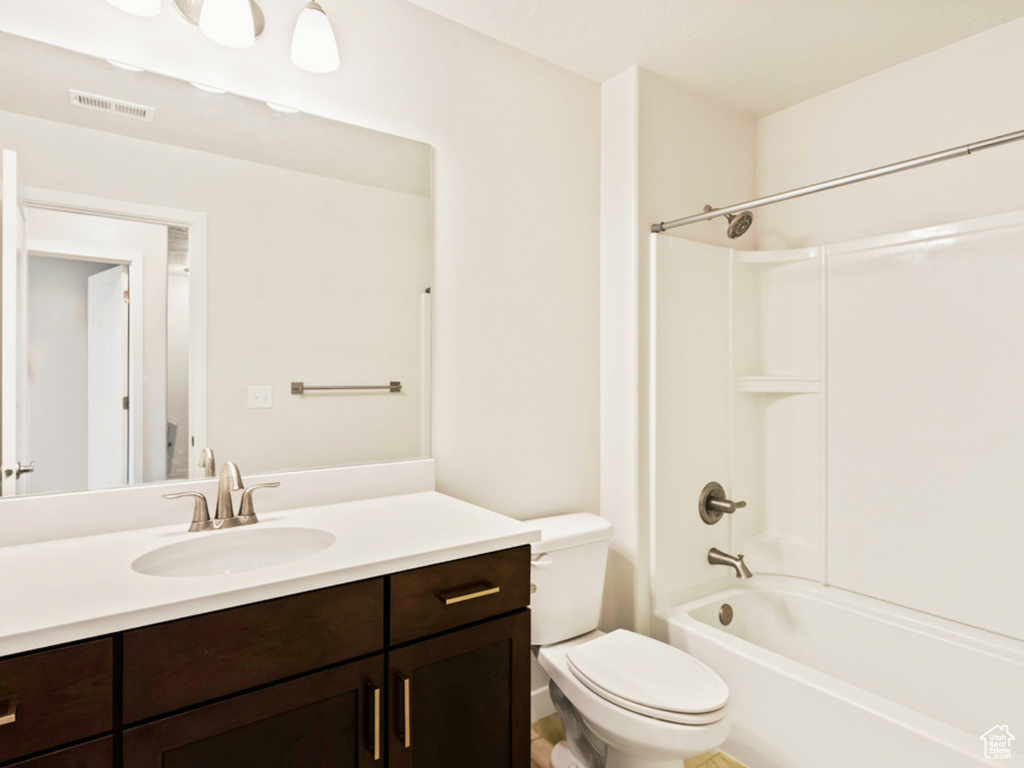 Full bathroom featuring vanity, toilet, and shower / washtub combination