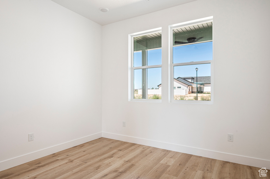 Empty room with light hardwood / wood-style floors