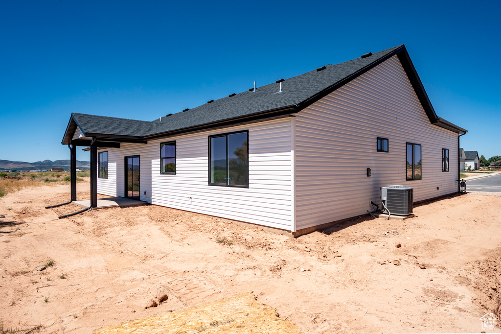 Rear view of house featuring central air condition unit