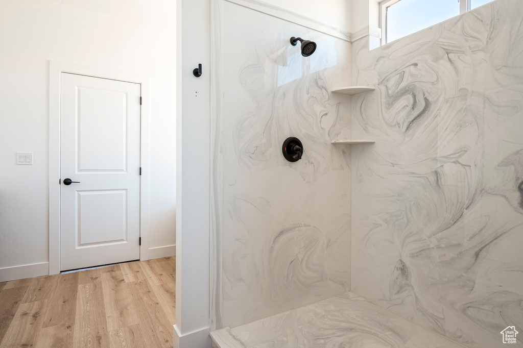 Bathroom featuring hardwood / wood-style floors and walk in shower