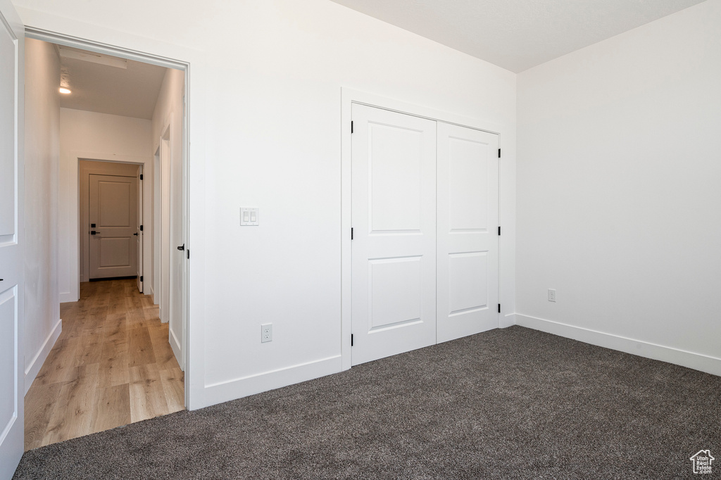 Unfurnished bedroom featuring a closet and light hardwood / wood-style floors