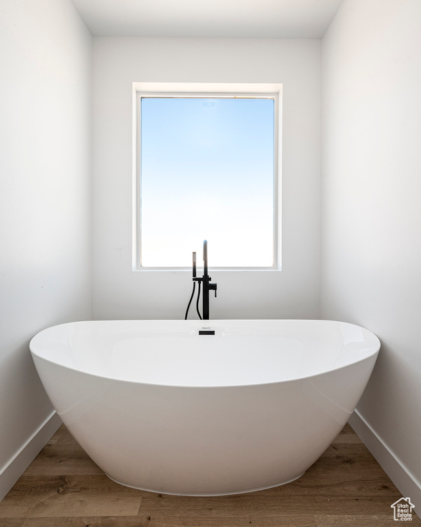 Bathroom featuring hardwood / wood-style flooring and plenty of natural light