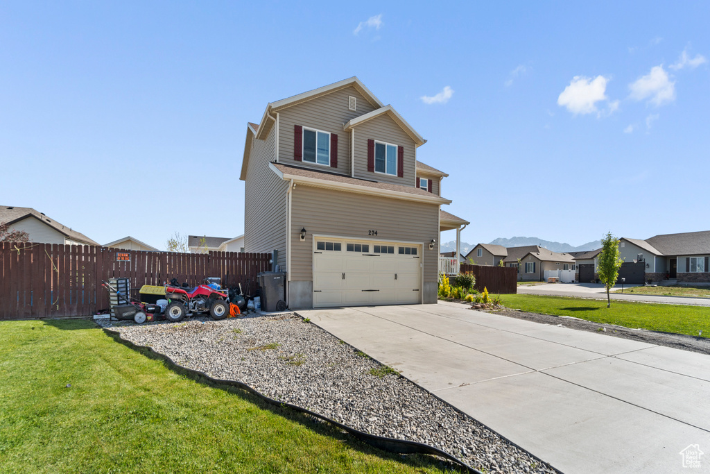 Front facade with a front lawn and a garage