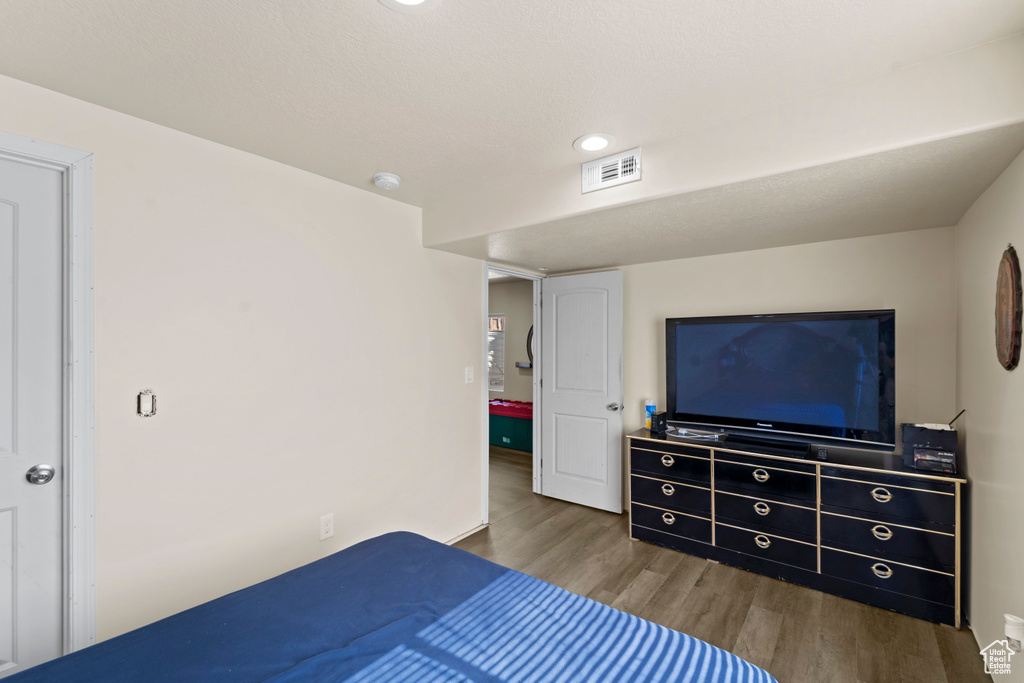 Bedroom with hardwood / wood-style flooring