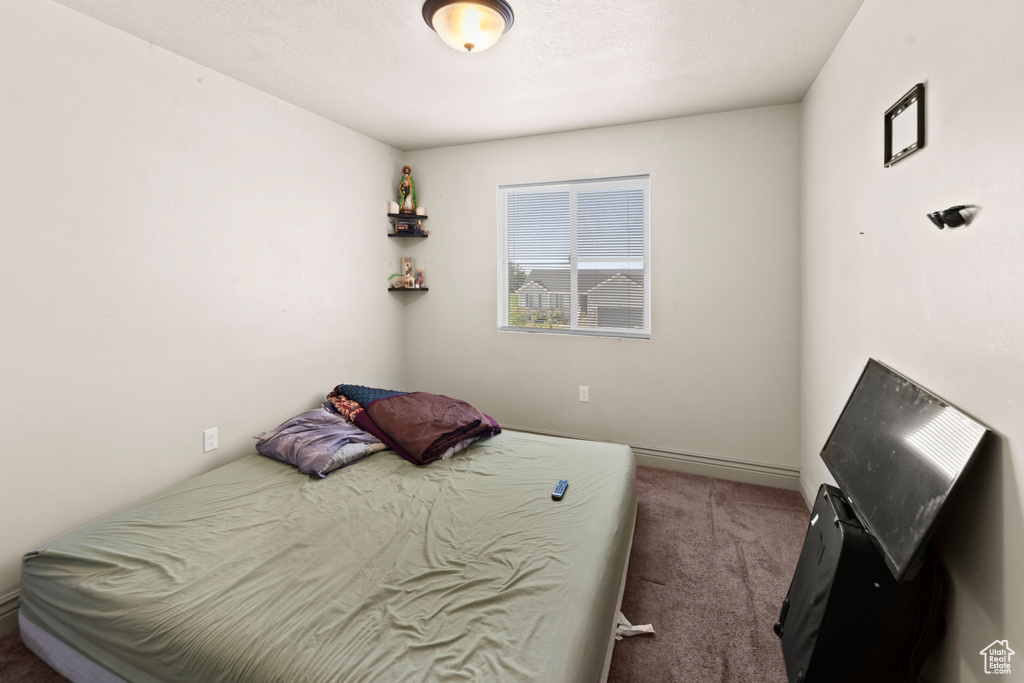 Bedroom with dark colored carpet