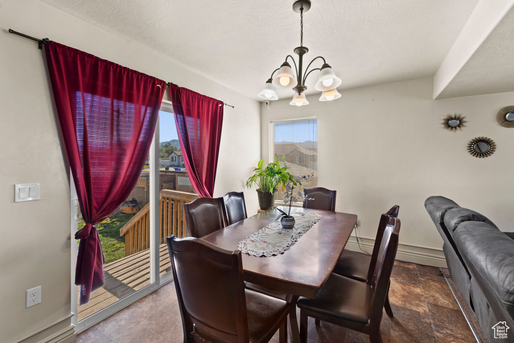 Tiled dining area with a chandelier