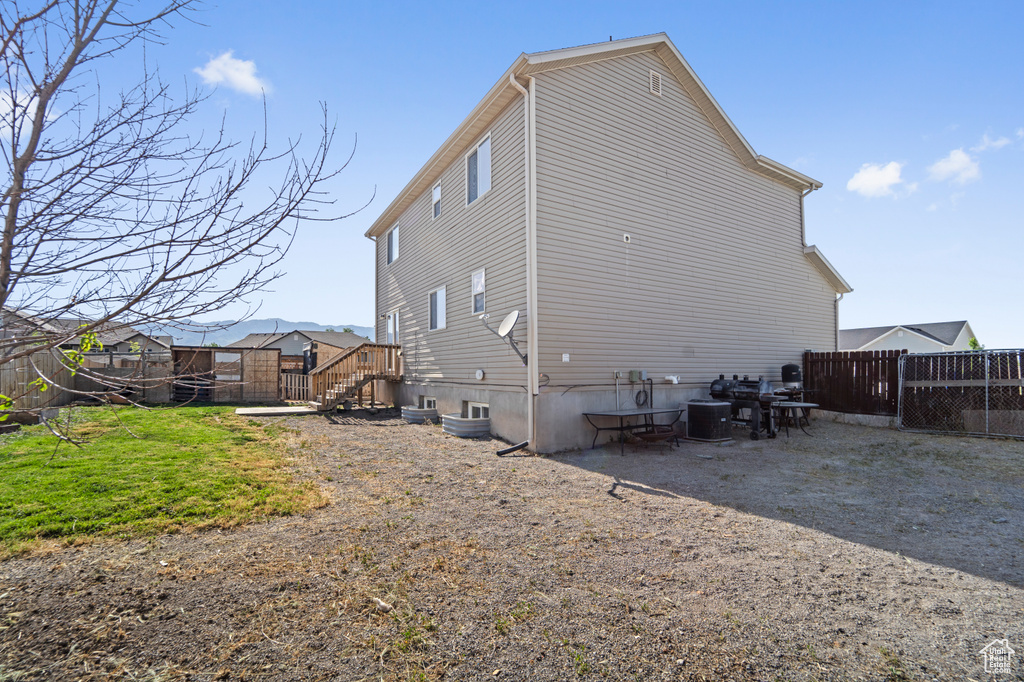 Rear view of property with central AC unit