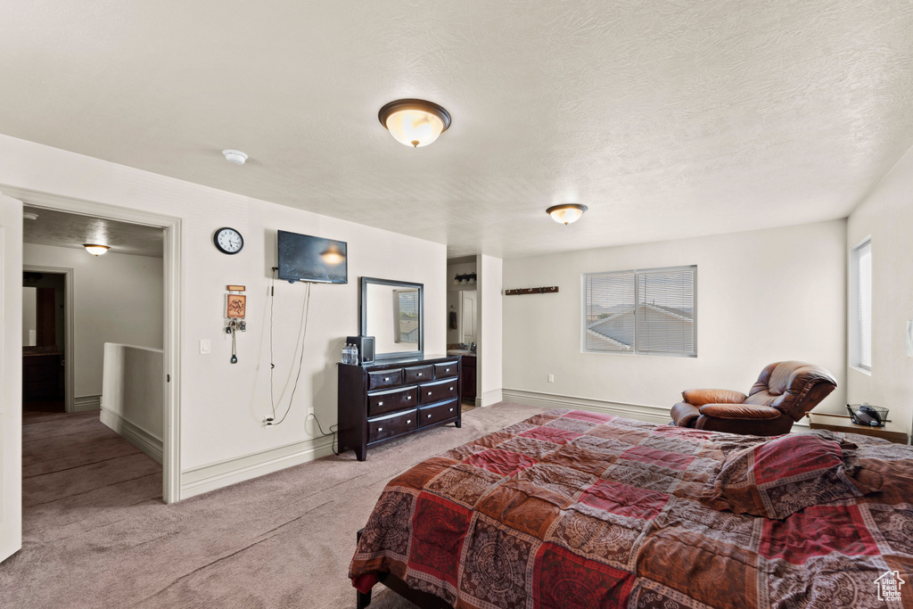 Bedroom featuring a textured ceiling and carpet flooring