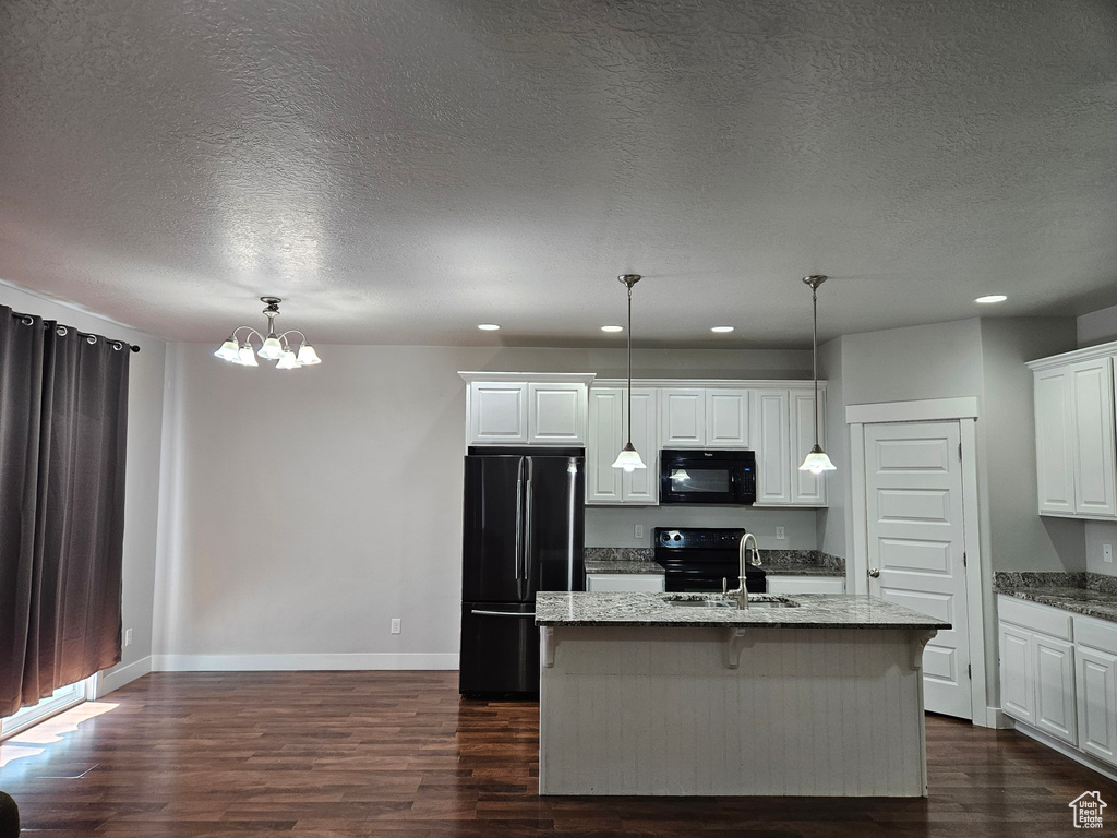 Kitchen featuring black appliances, sink, dark hardwood / wood-style floors, and white cabinetry