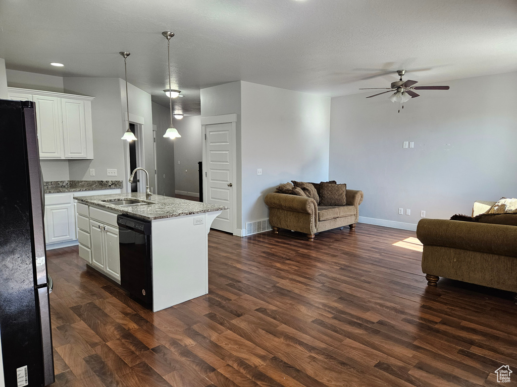 Kitchen with dark hardwood / wood-style floors, ceiling fan, black appliances, white cabinets, and sink