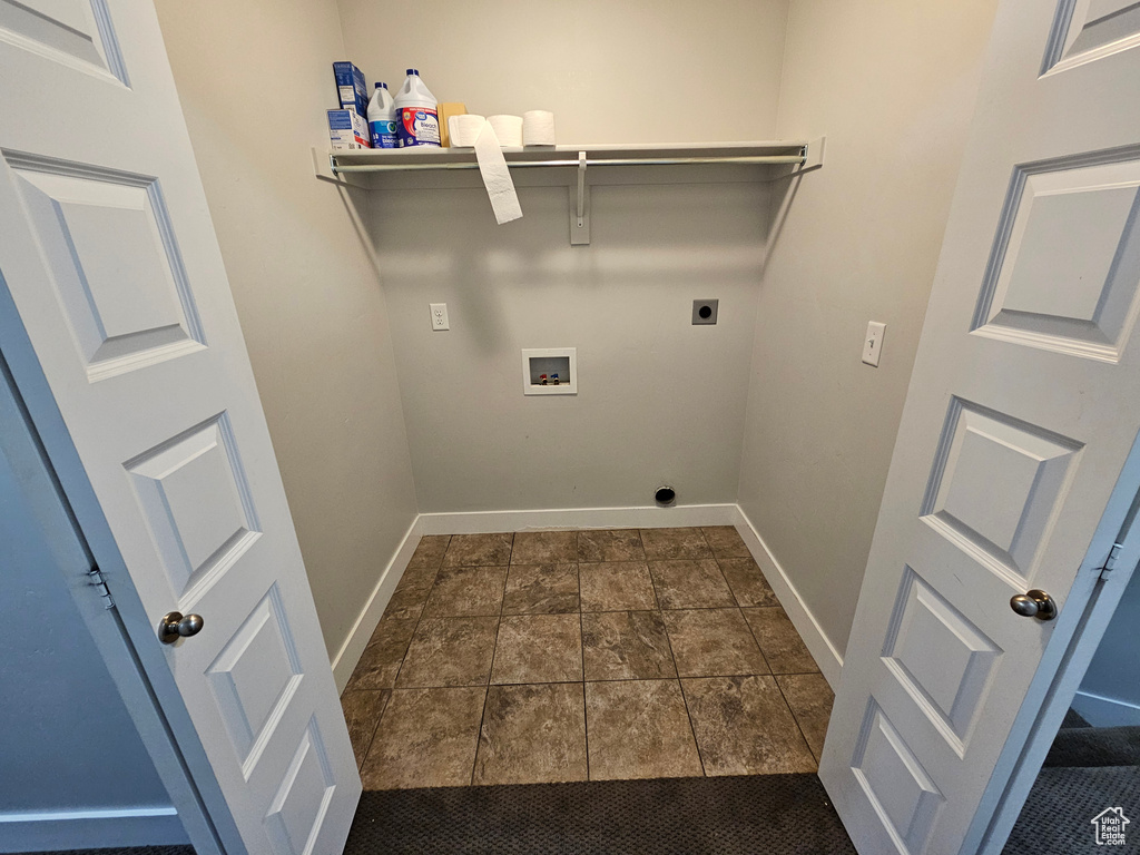 Laundry area featuring hookup for a washing machine, hookup for an electric dryer, and dark tile floors