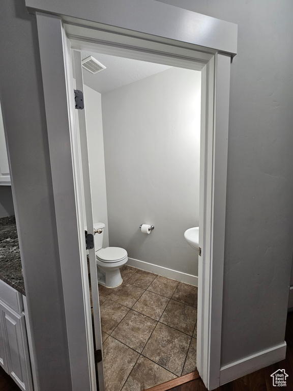 Bathroom with tile floors, toilet, and vanity