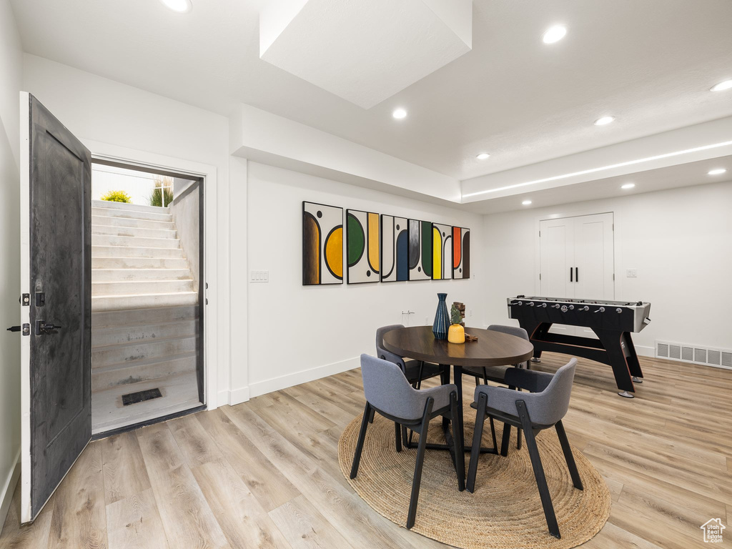 Dining room with light hardwood / wood-style flooring