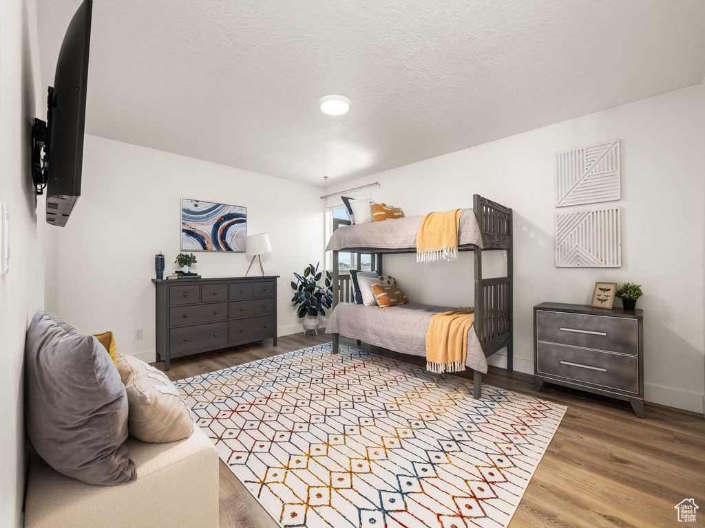 Bedroom with wood-type flooring and a textured ceiling