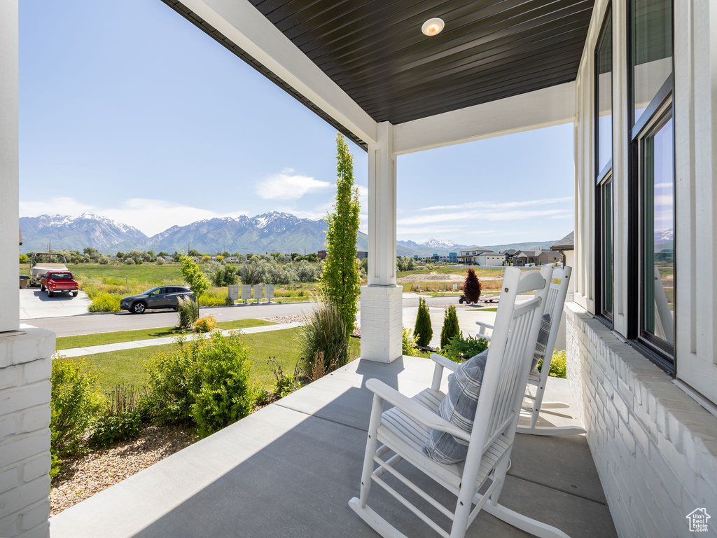 View of patio / terrace with a mountain view and covered porch