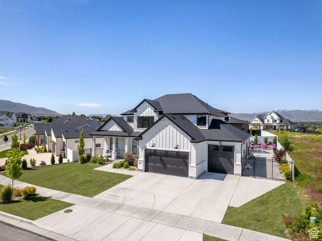 View of front of house with a front yard and a garage