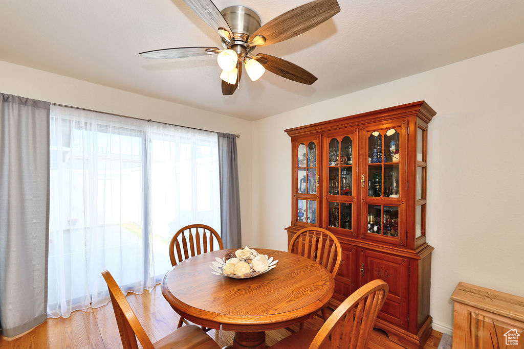 Dining area with ceiling fan and light hardwood / wood-style floors